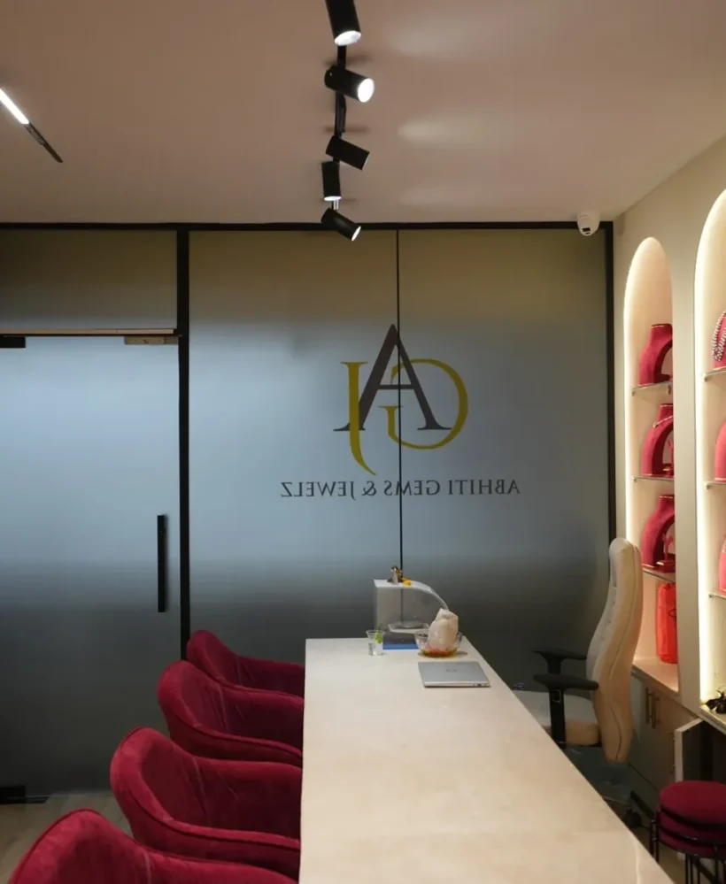 Entrance glass door with logo and red seating, Abhiti Gems & Jewelz, Basheerbagh, Hyderabad, interior by Homasm Interiors